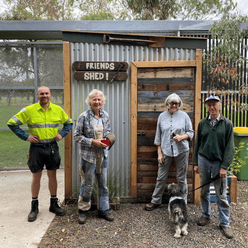 Brandon standing with three members of the Friends of Albert Park group, in front of their new garden shed.