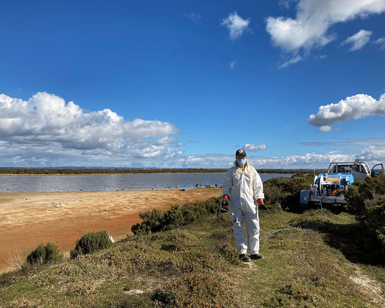 Ranger in full PPE getting ready to spray weeds