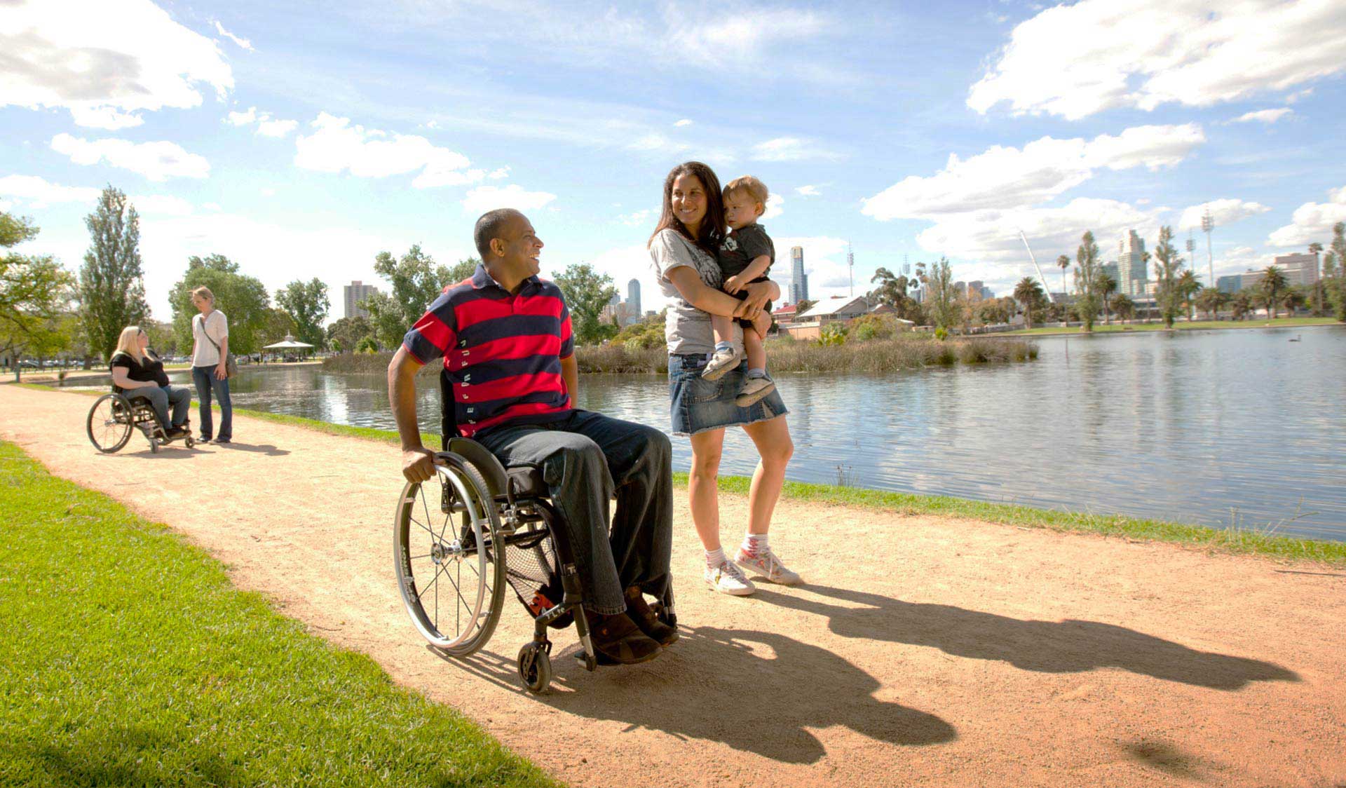 A family walking around Albert Park Lake