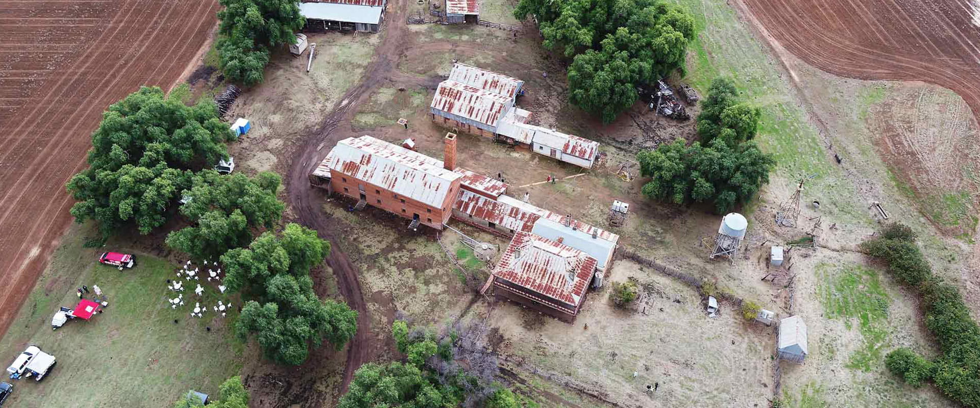 An aerial view of the Historic Mill surrounded by farmland.