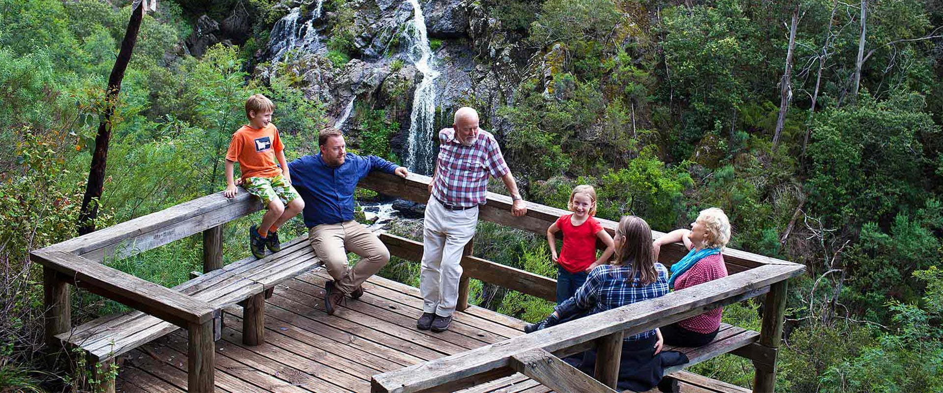 Three generations from the same family stop to chat and look at a Waterfall in the Alpine National Park near Buchan.