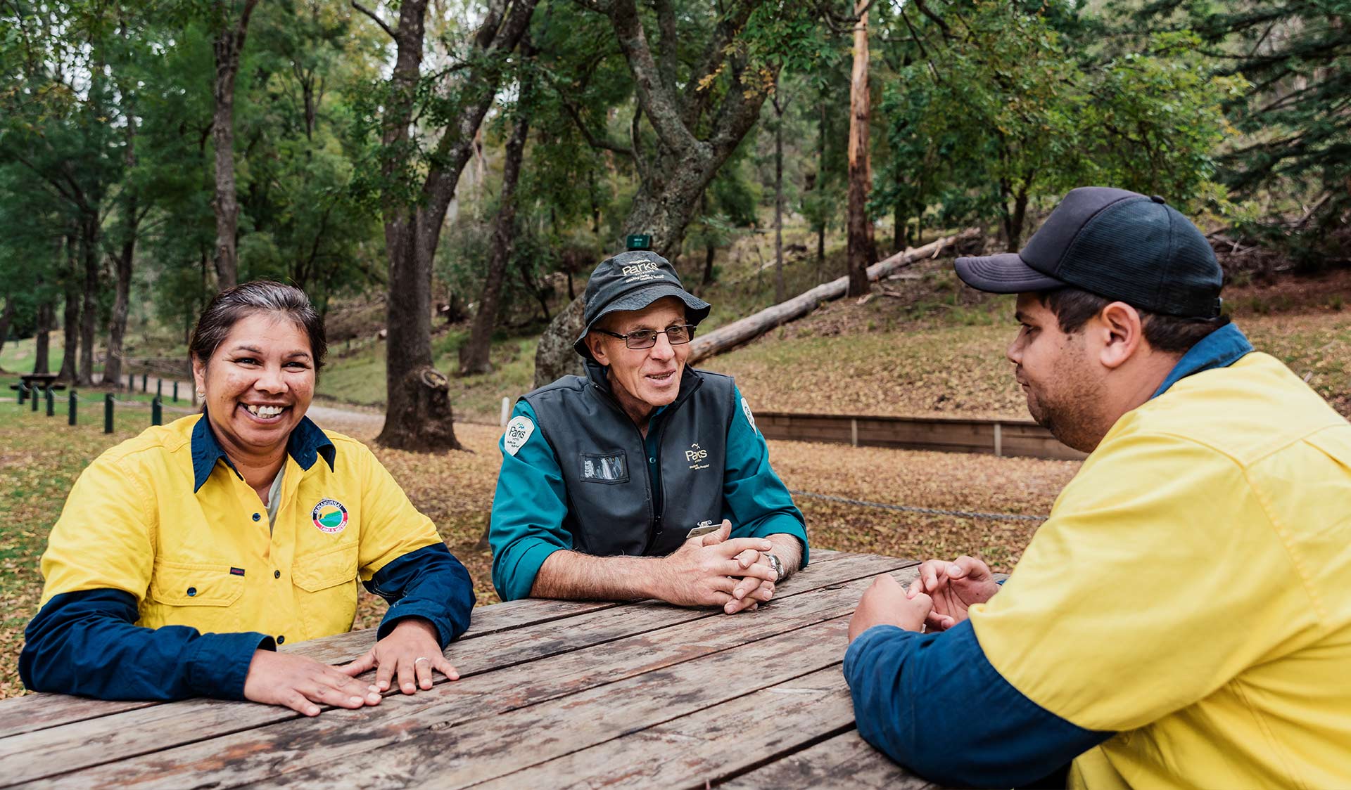 Representatives from the Gunaikurnai Land and Water Aboriginal Corporation sit with Parks Victoria Rangers at Buchan Caves Reserve.