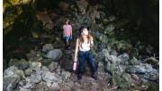 A young couple walk through a cave in Budj Bim National Park