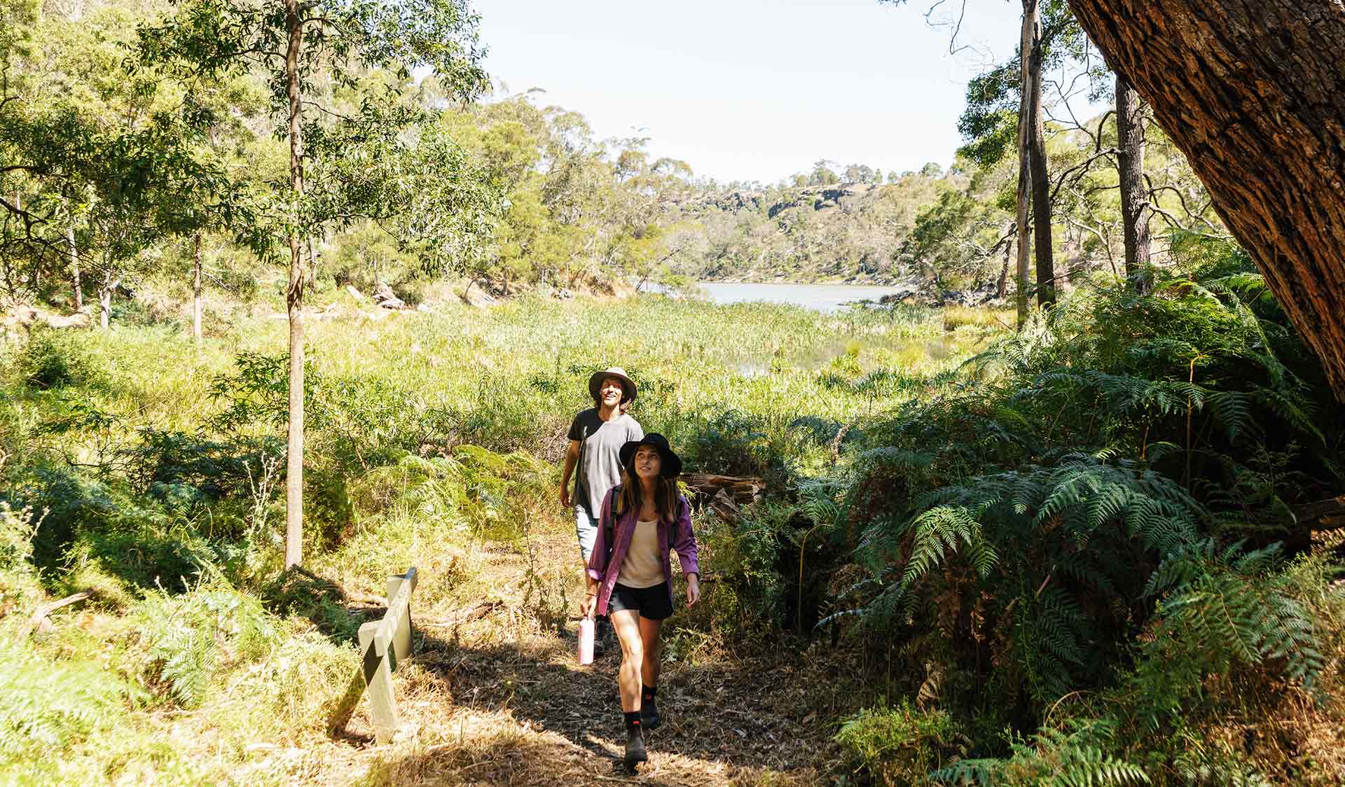 A young woman leading a man on a walk through Budj Bim National Park