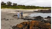Two friends walk along the high tide mark on Maitland Beach at Cape Liptrap Coastal Park