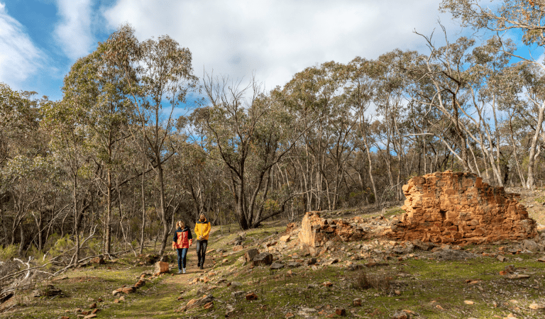 A couple walks through the Eureka Reef section of Castlemaine Diggings National Heritage Park