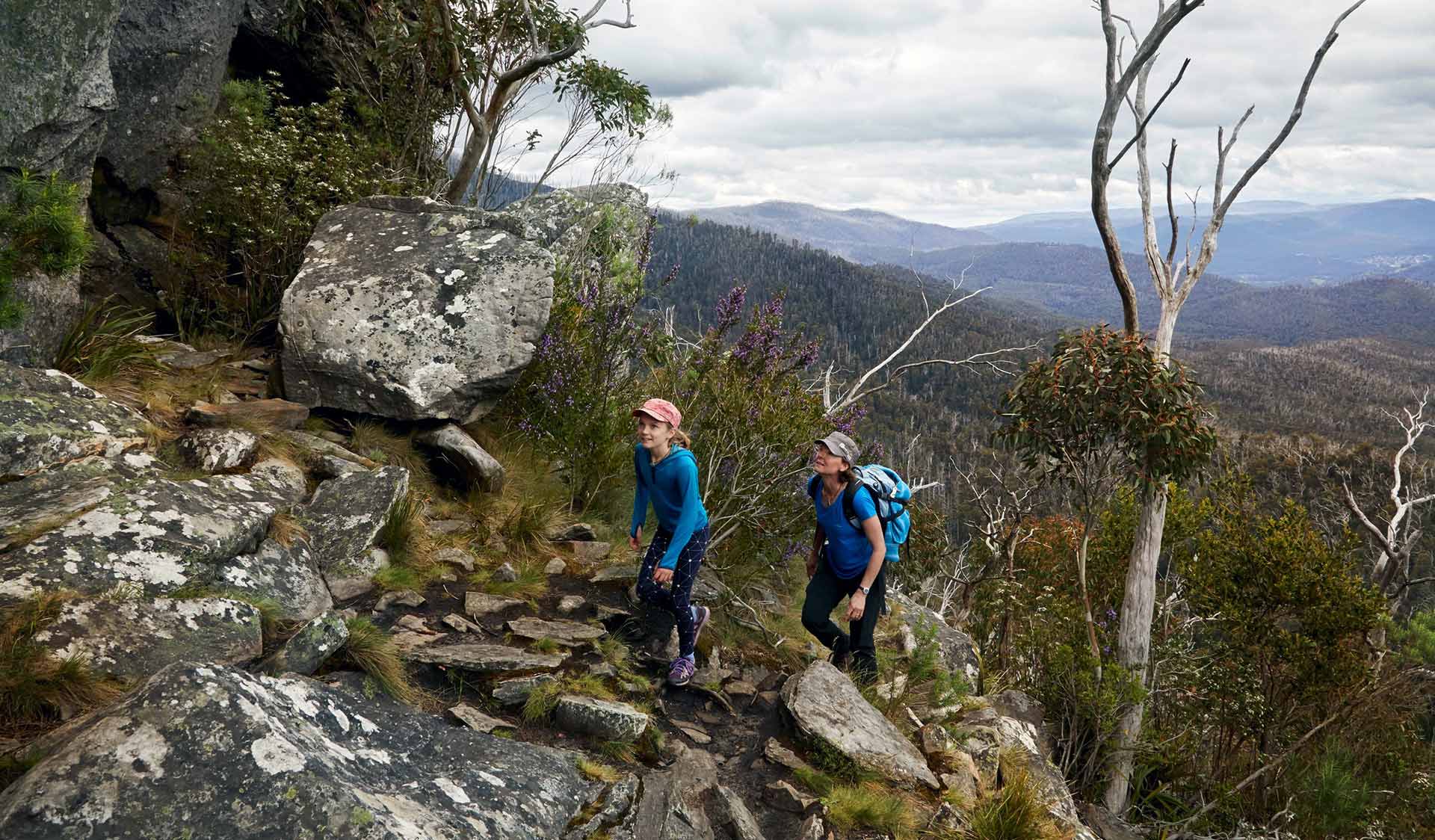 A mother and her 10 year-old daughter walk up from South Jawbone surrounded by views of the Yarra Ranges.