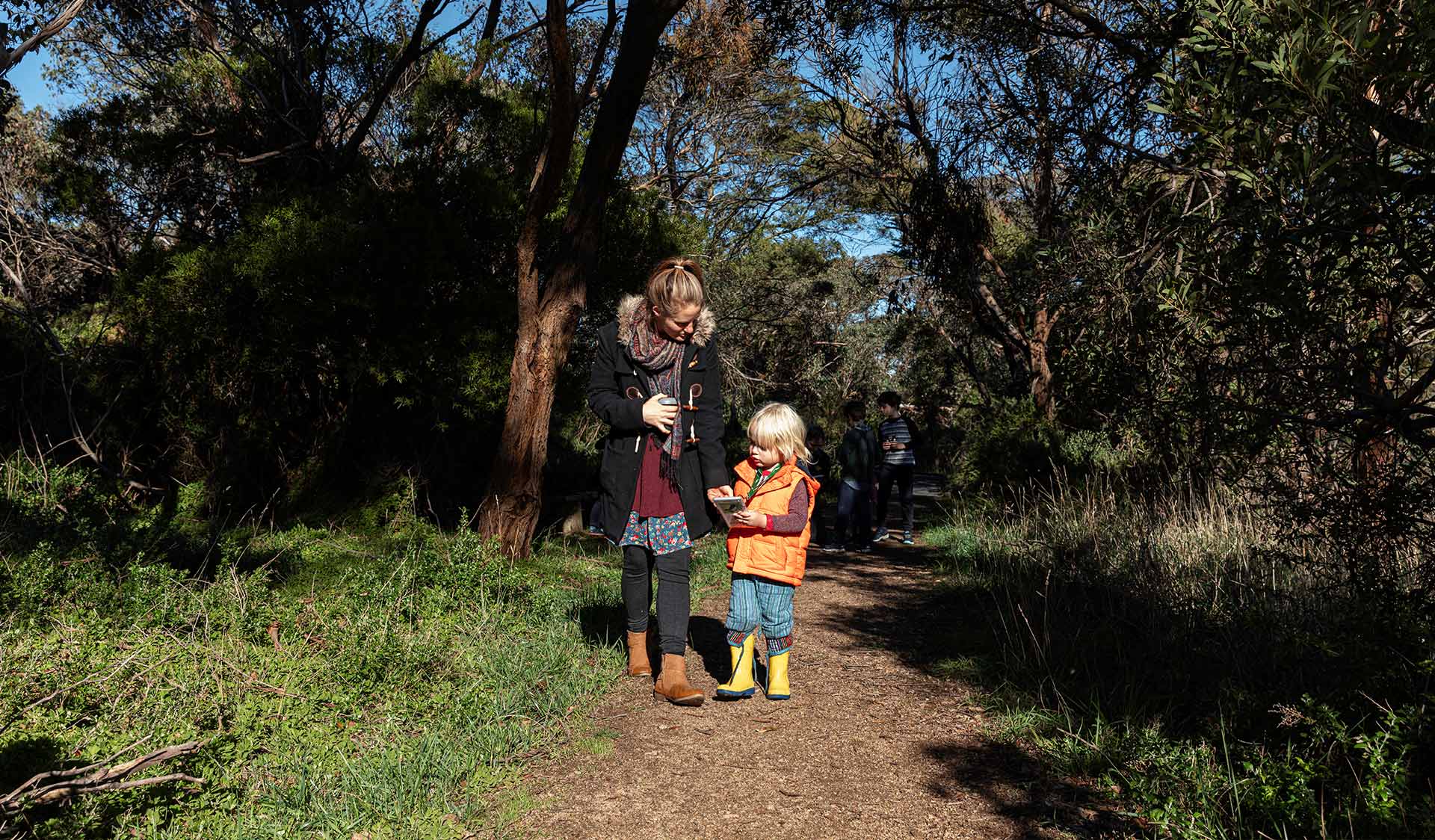 A mother and child walks along the path near by Coolart Homestead