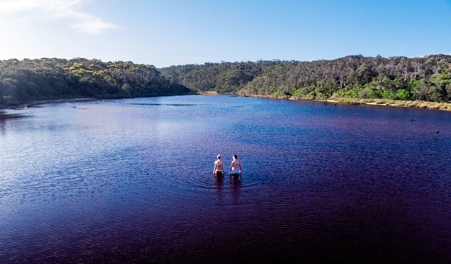 Two friends go for a swim in Lake Elusive in Croajingolong National Park.