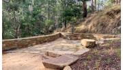 A stone paved area surrounded by bushland