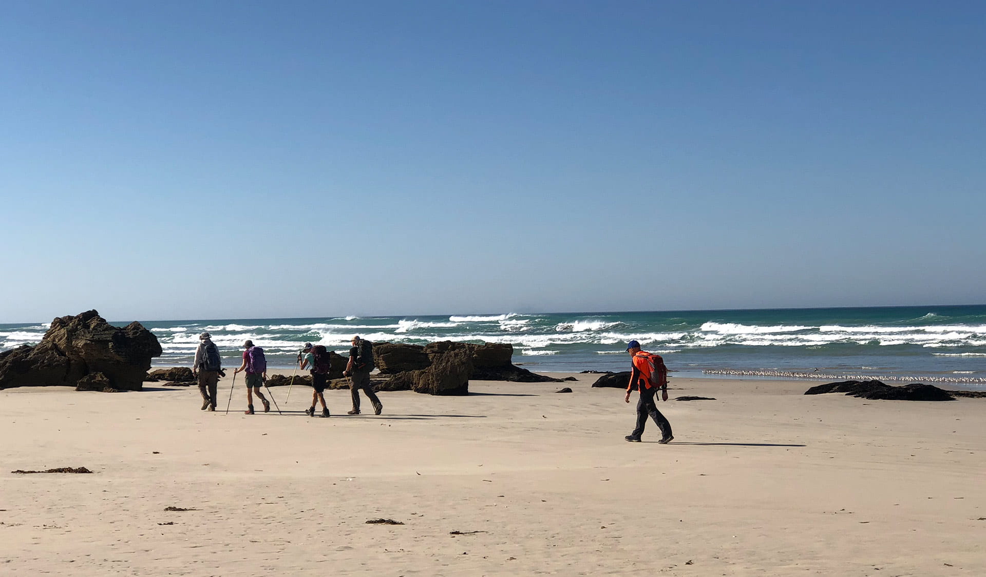 A group of hikers along on the Great South West Walk along the beach at Discovery Bay Coastal Park