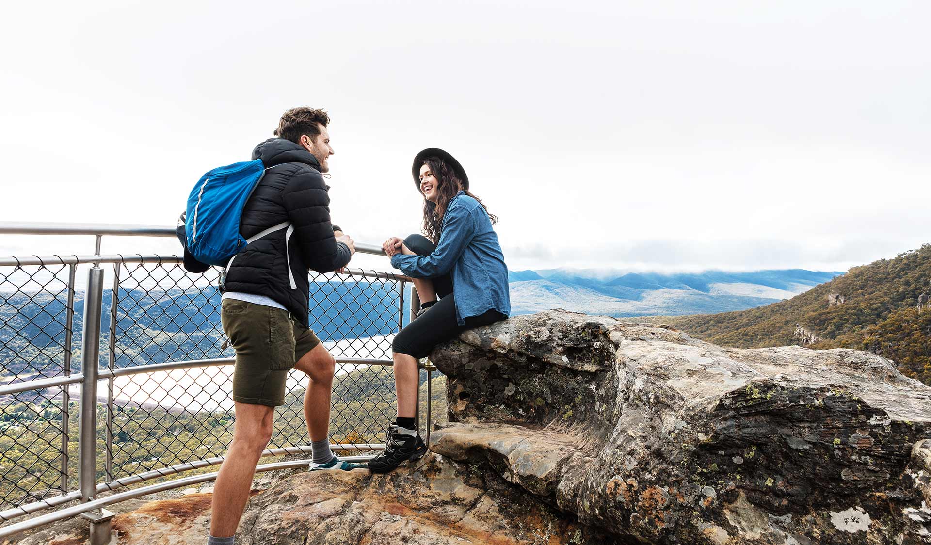 A couple in their twenties chat at the Lakeview lookout in the Grampians National Park. 