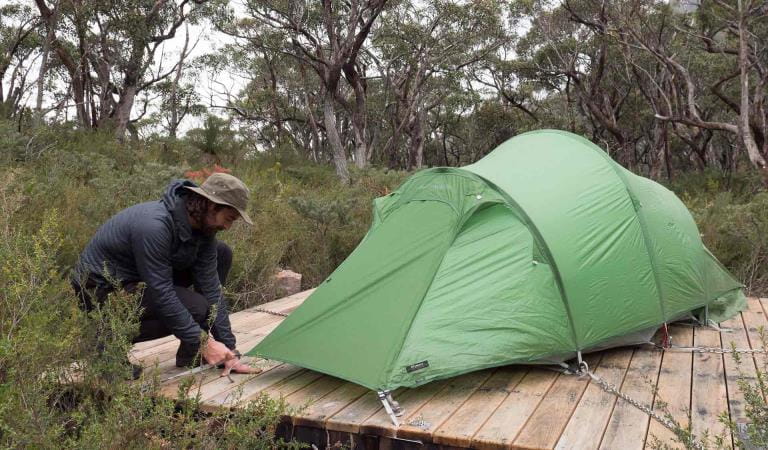 A man sets up his tent at Duwal hiker camp at the end of central section 3 on the GPT