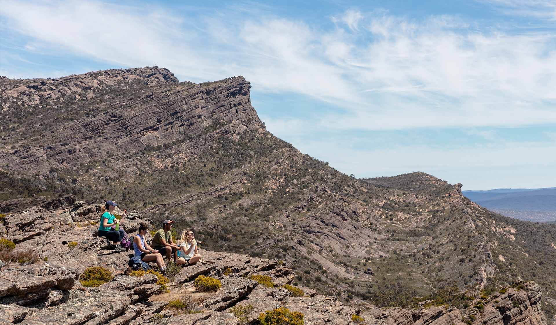 A group stops for a drink below the summit of the Gar