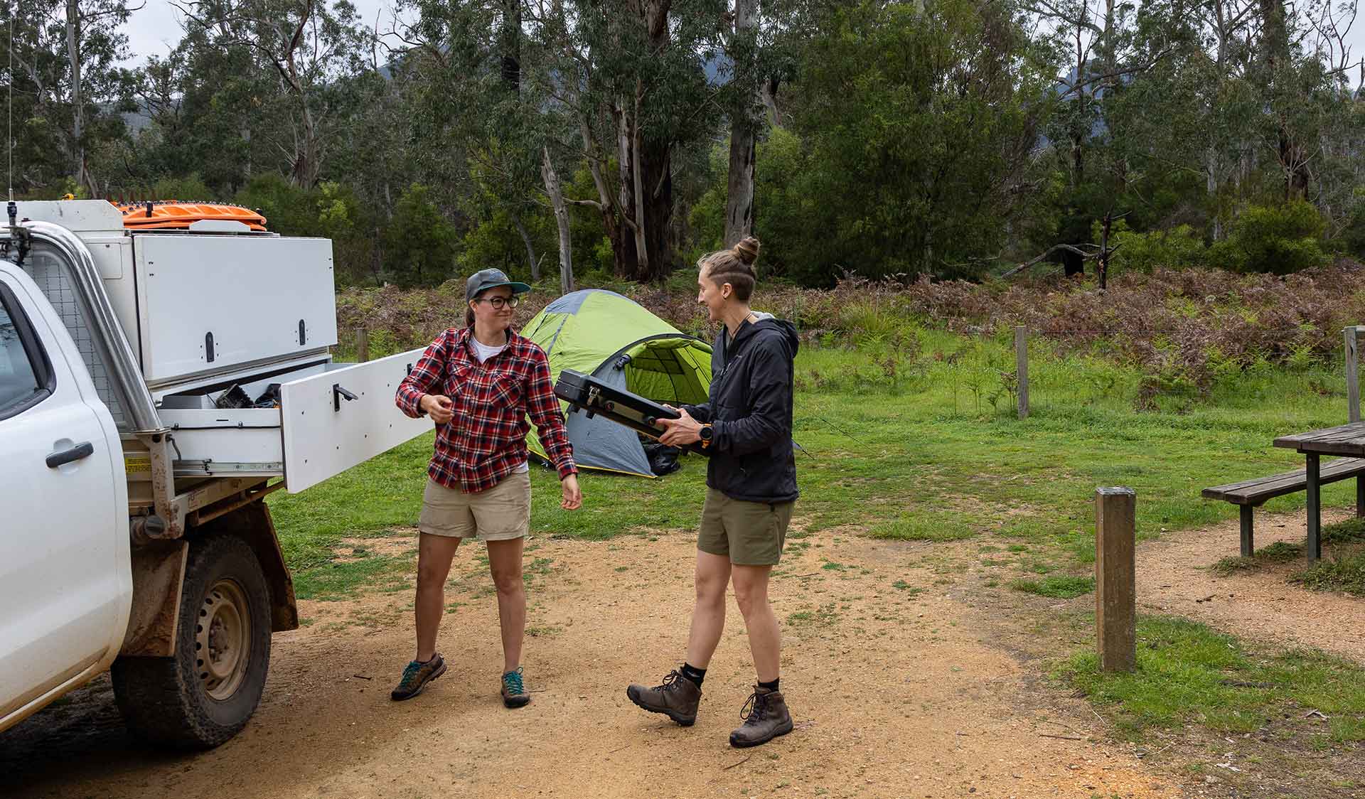 Two women unpack camping great from their ute at Jimmy Creek Campground at the Grampians National Park