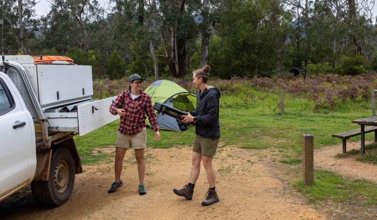 Two women unpack camping great from their ute at Jimmy Creek Campground at the Grampians National Park
