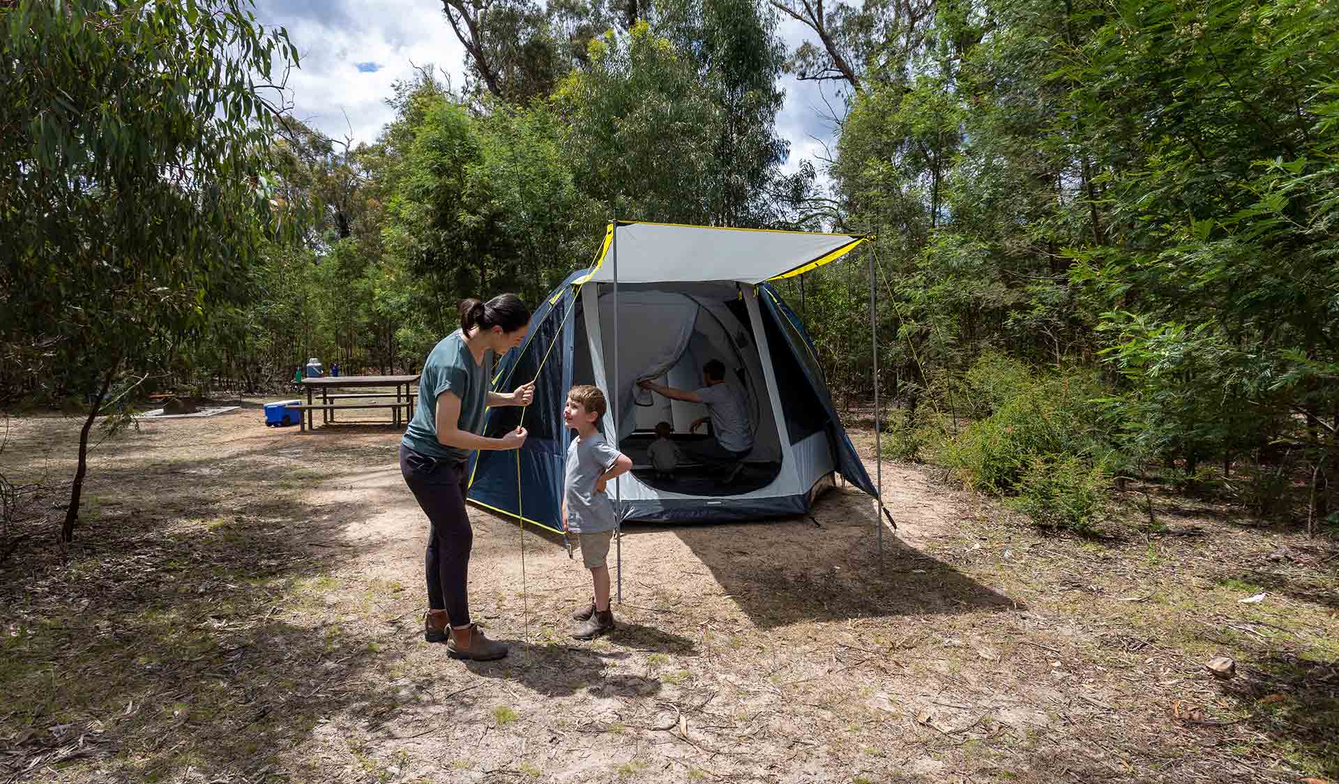 Mother and her young son finish off setting up their tent at Troopers Creek Campground at the Grampians National Park