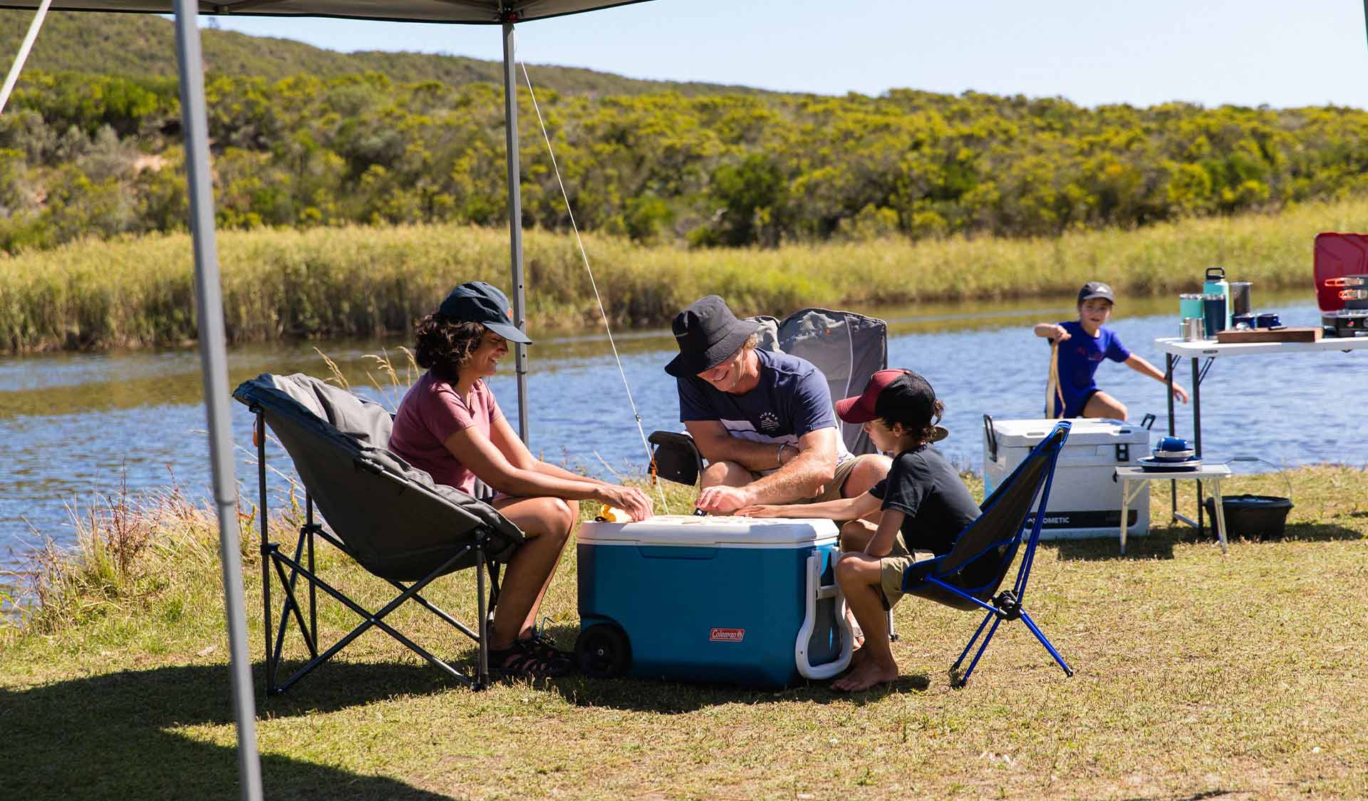 A family camps on the shores of Aire River in the Great Otway National Park