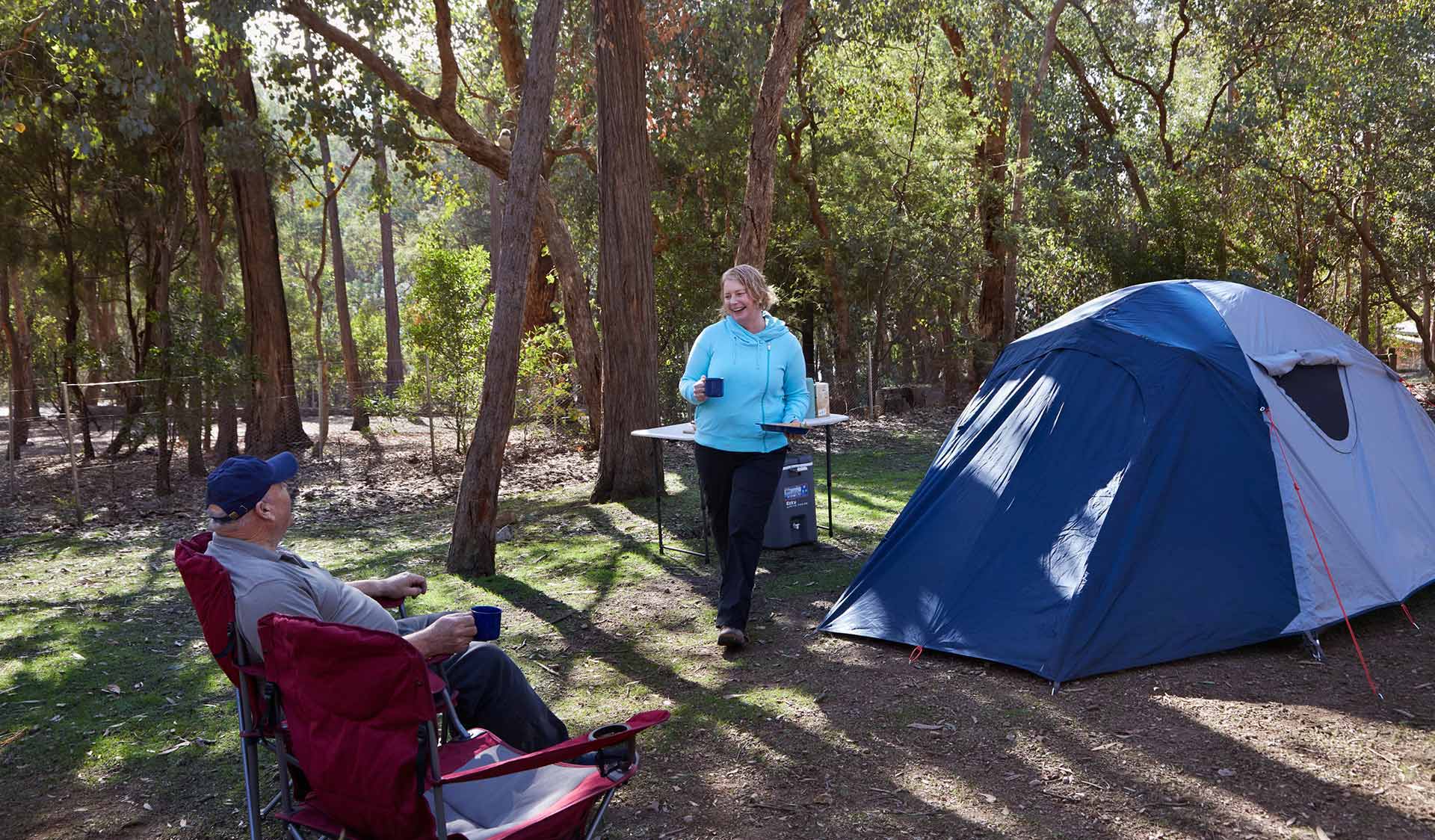 A couple prepare a meal at their camp ground at Lakeside in Fraser Camping Area in the Lake Eildon National Park.