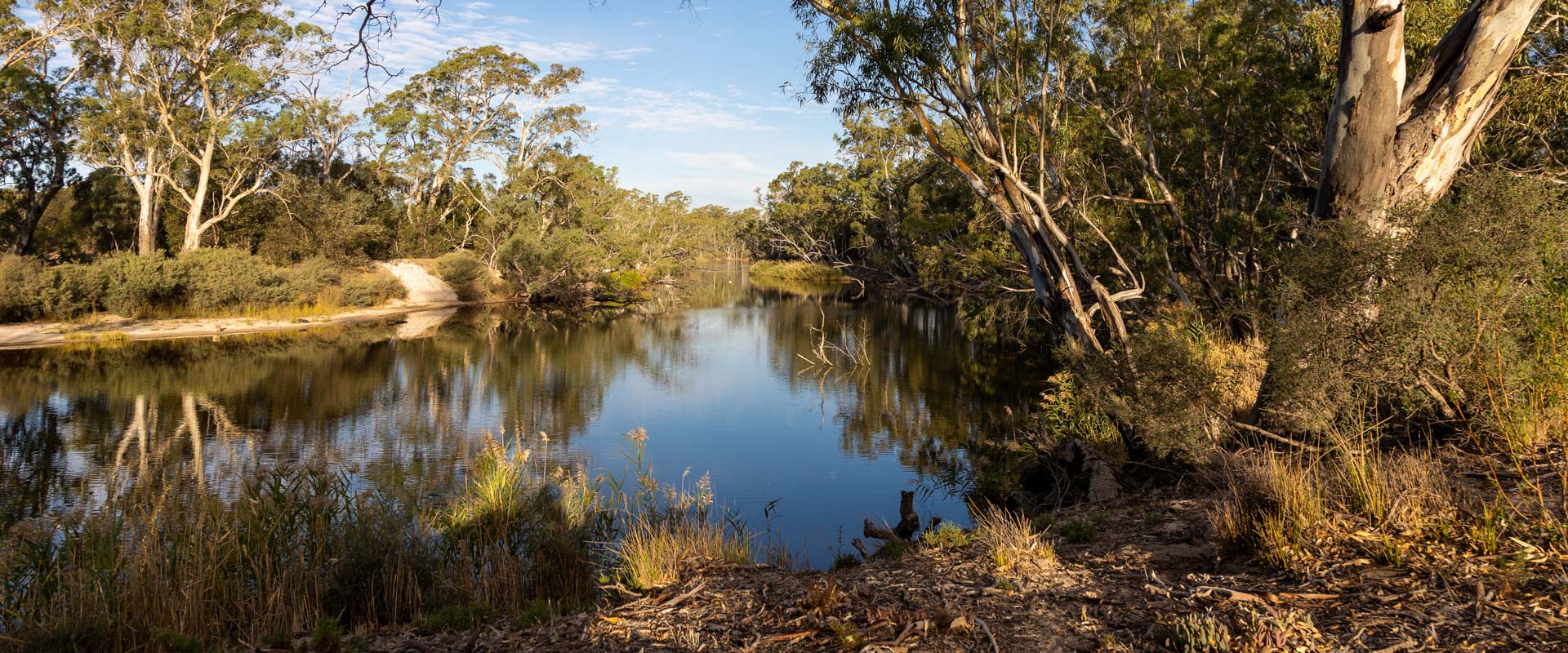 A winding river in a rugged bushland landscape. 