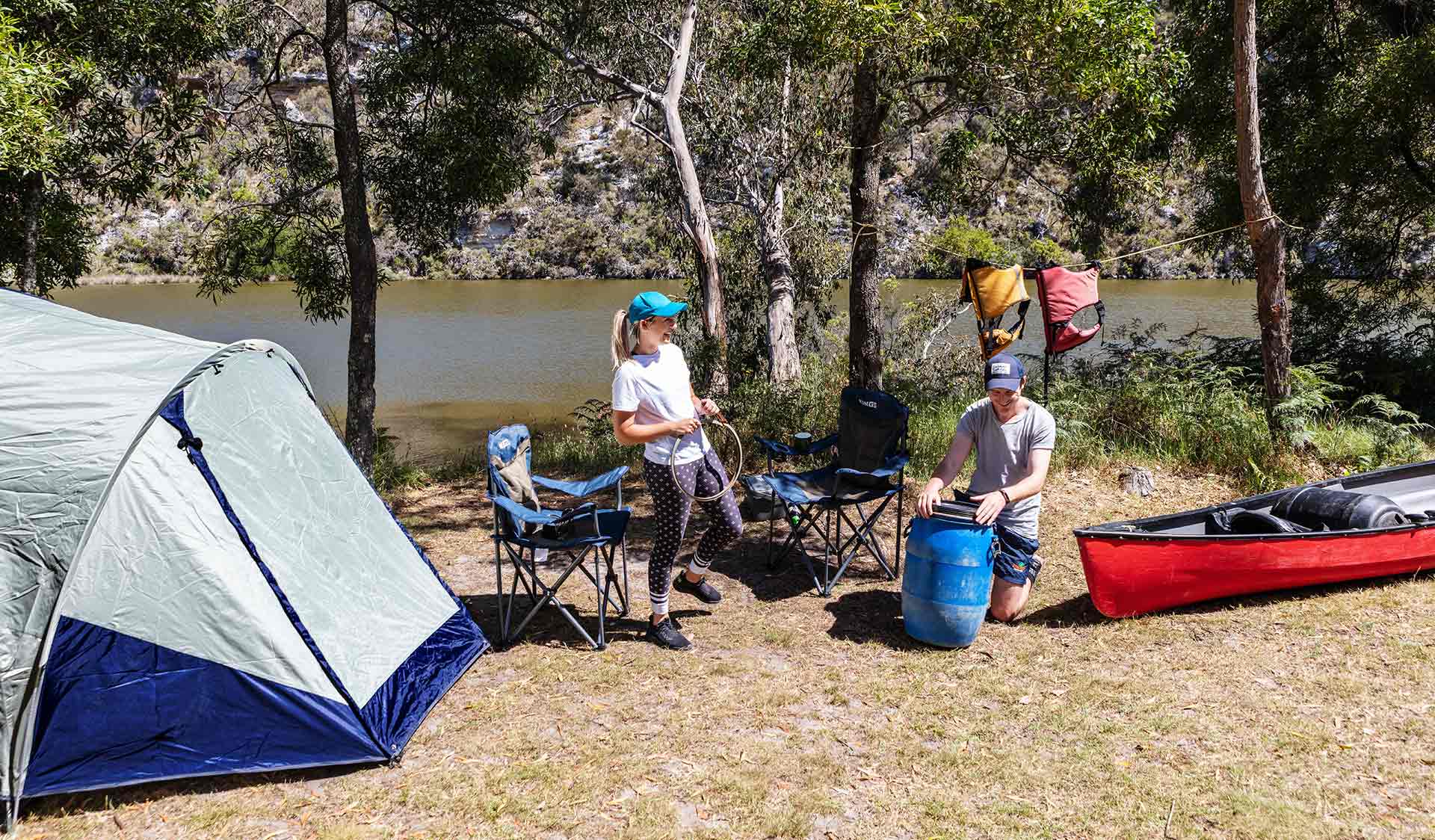 Two campers laughing while relaxing at their campsite by the Glenelg River