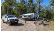 A 4WD and caravan setup next to a picnic table at Pritchards Campground at Lower Glenelg National Park