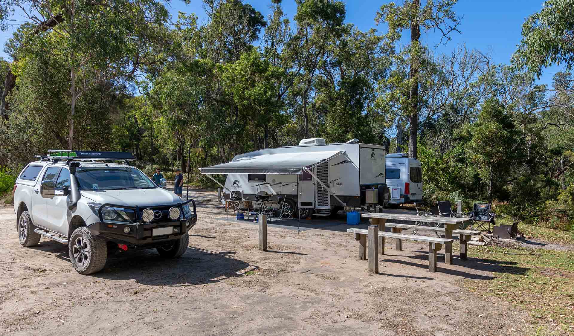 A 4WD and caravan setup next to a picnic table at Pritchards Campground at Lower Glenelg National Park