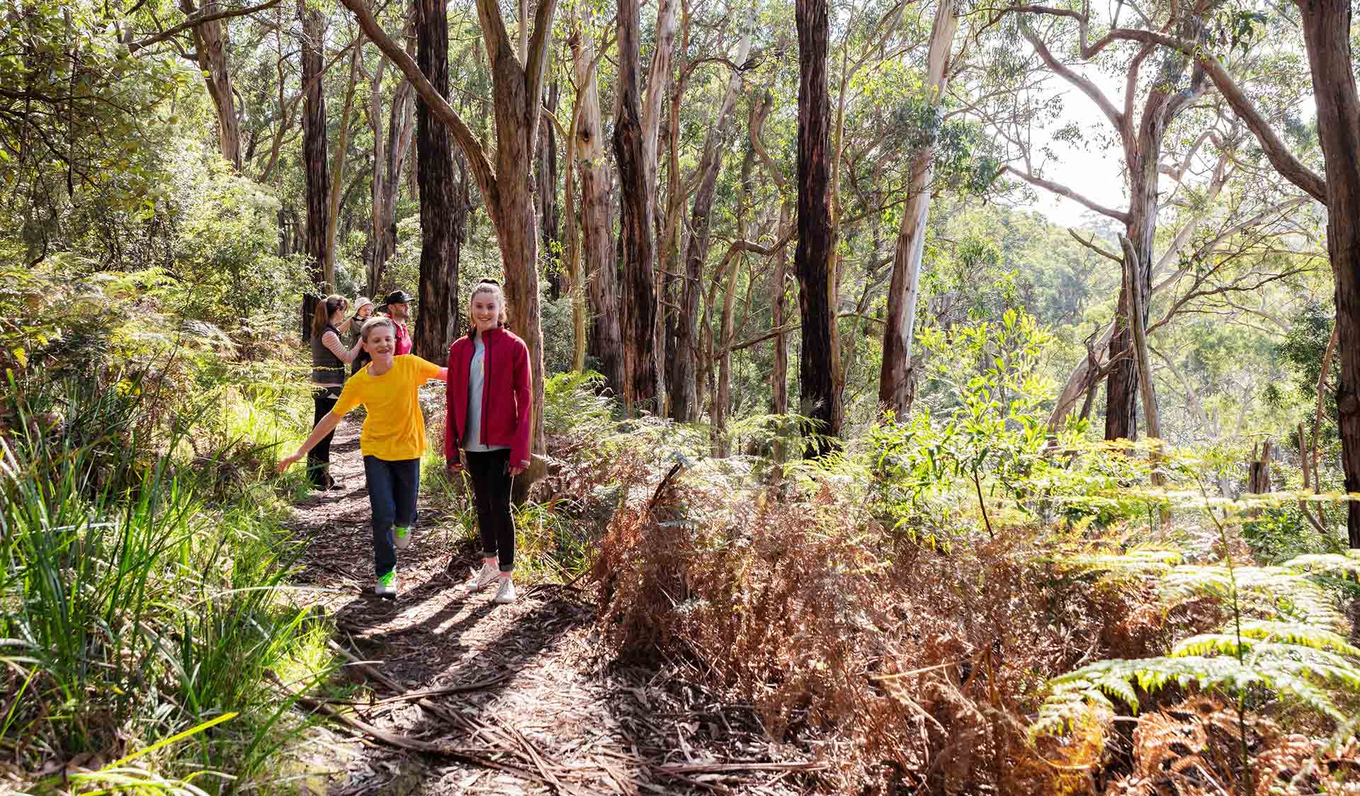 A husband and wife with their three children walk through Baldrys Crossing.