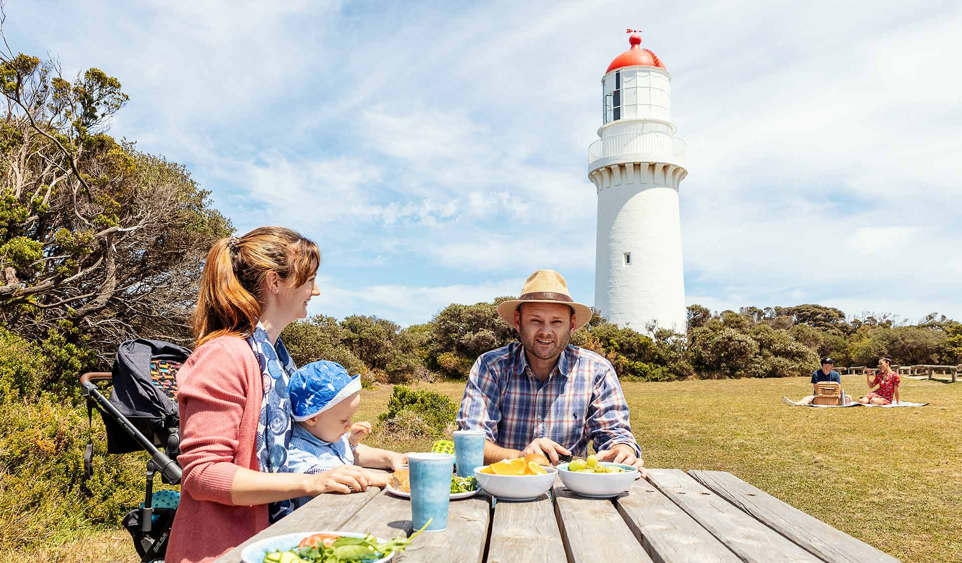 A young family eating at a picnic table at the Cape Schanck Lighthouse