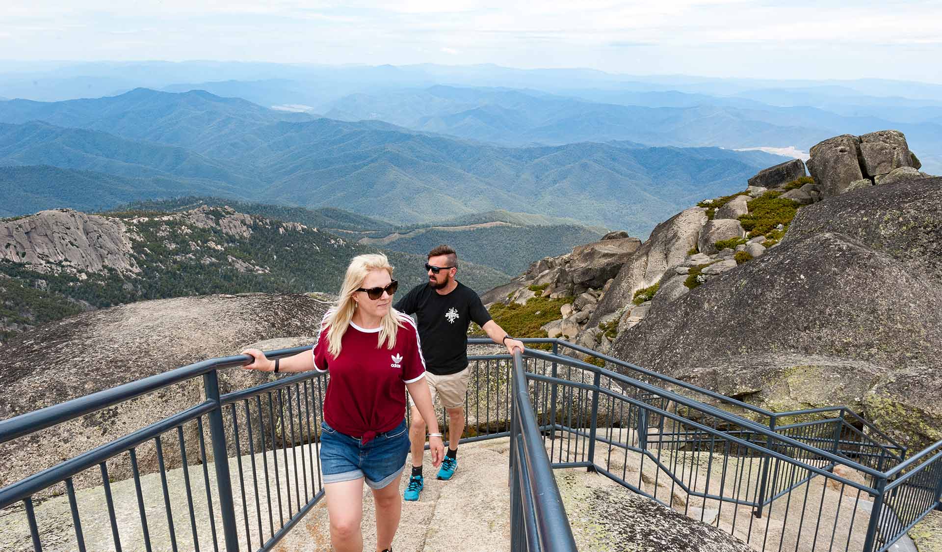 A couple in their thirties approach the summit lookout at the Horn of Mount Buffalo.