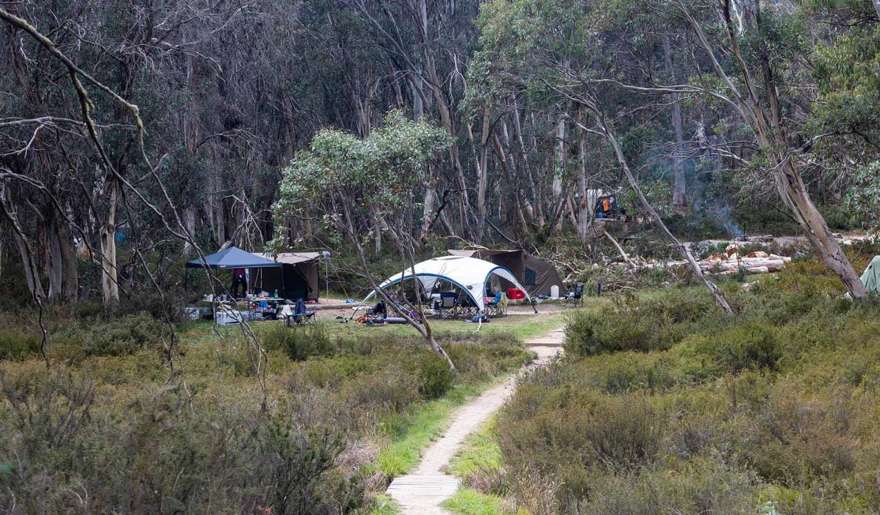 A path leads to tents at Lake Catani Campground at Mount Buffalo National Park