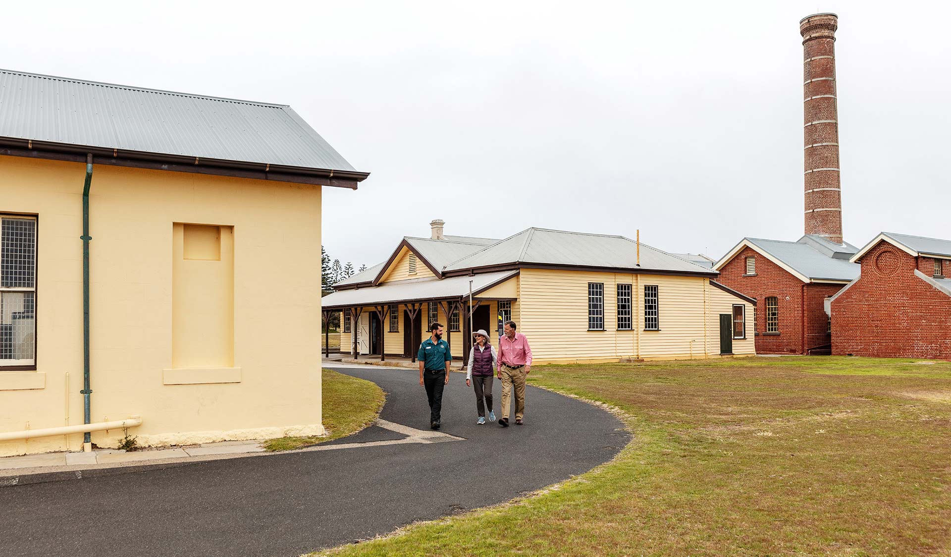A retired couple walk with a ranger through the quarantine station at Point Nepean.