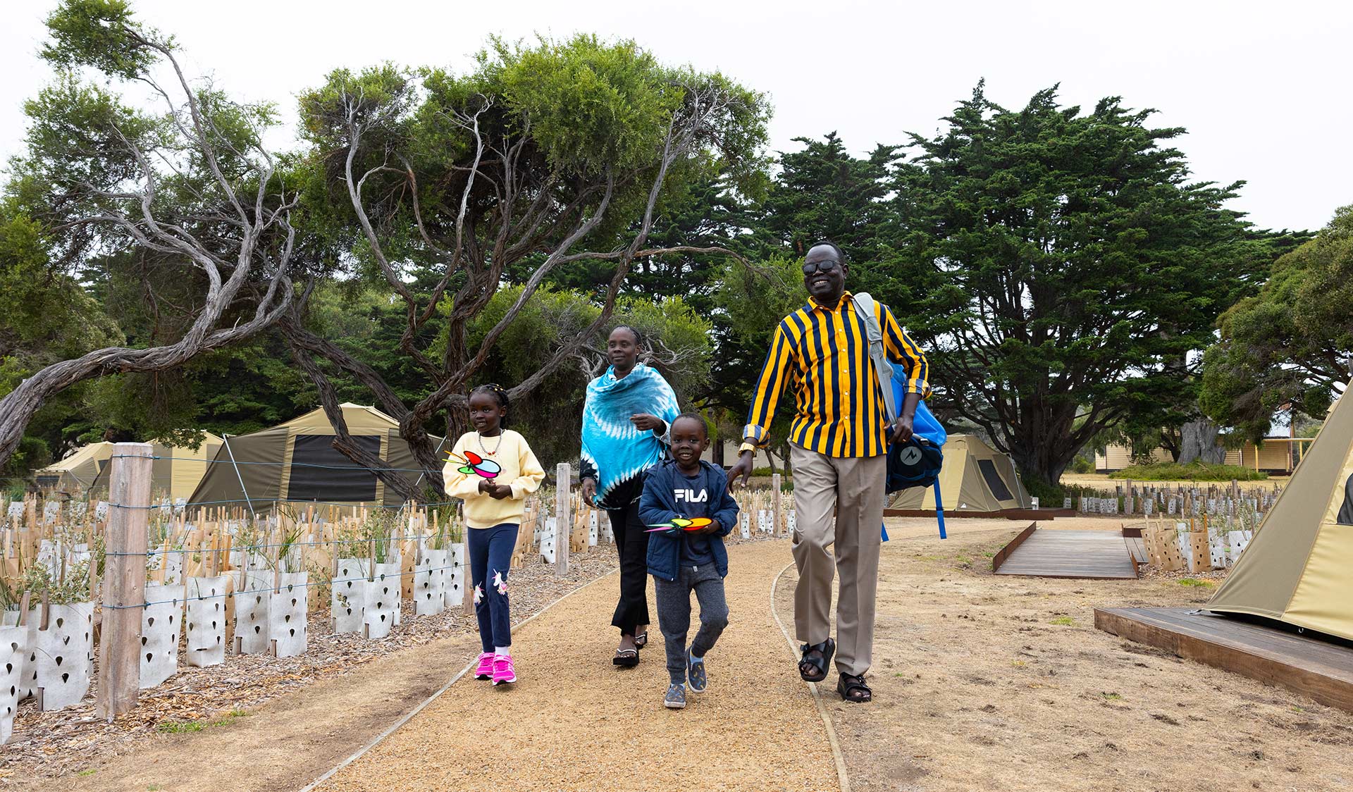A family of African background walk through the campground 