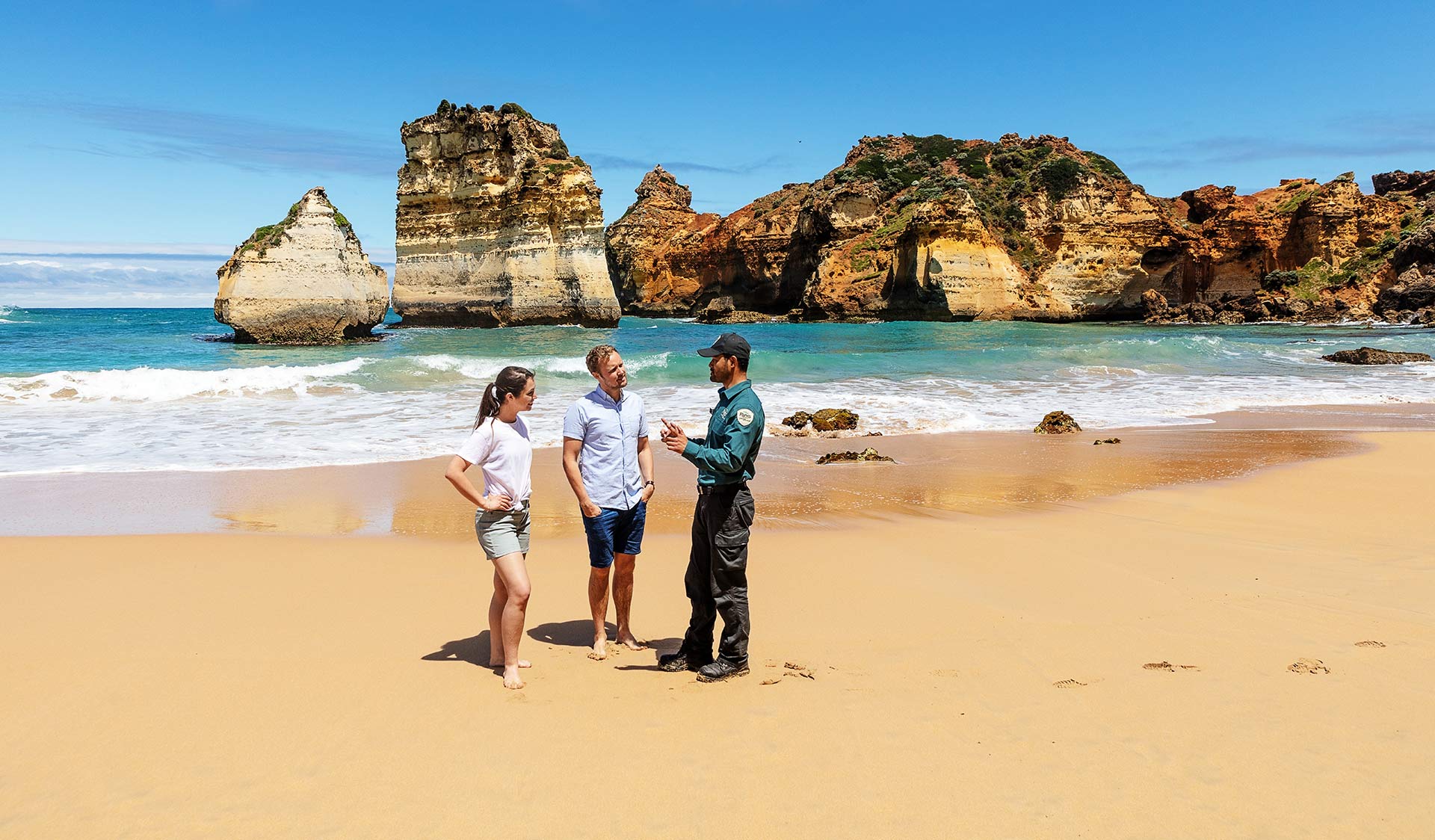 A couple talking to a Parks Victoria Ranger at Sandy Bay, Childers Cove