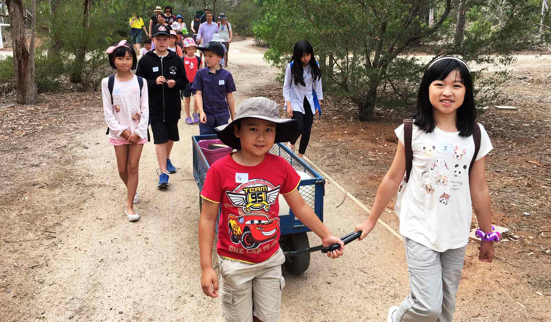 Children walk through Serendip Sanctuary to feed animals during a Junior Ranger Program. 