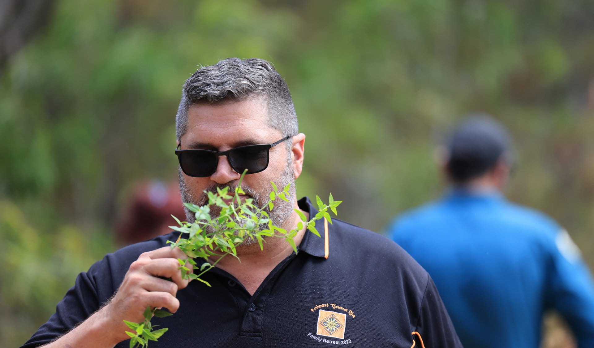 Man sniffing mint leaves at sensory garden