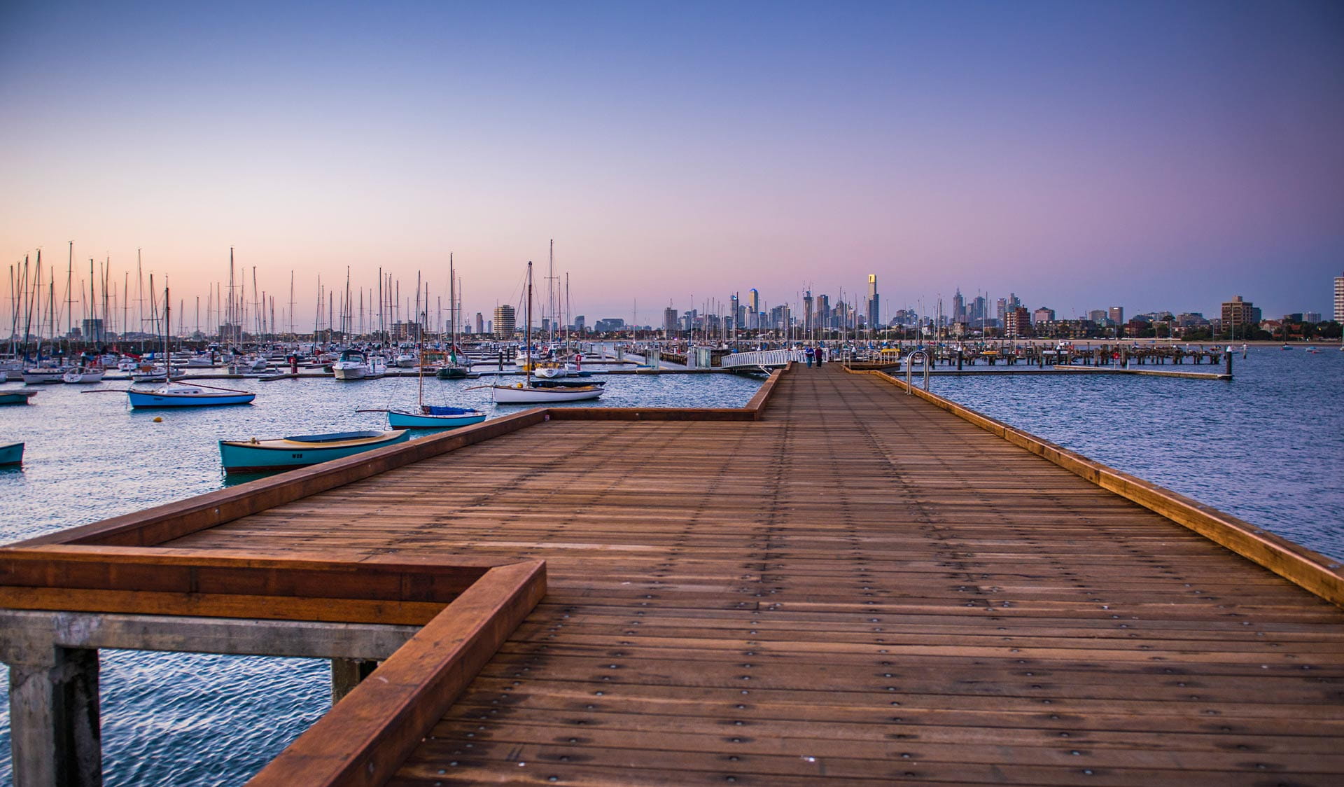 Sunset on St Kilda Pier with views of the CBD in the background.