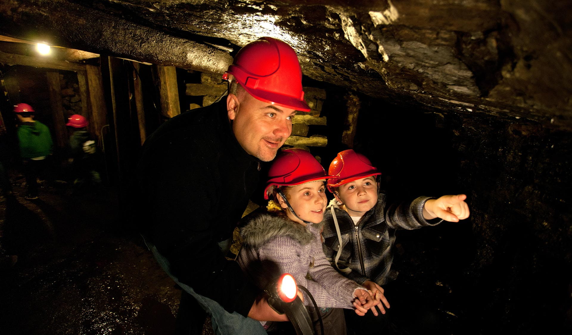 A father and his two children underground in the State Coal Mine.