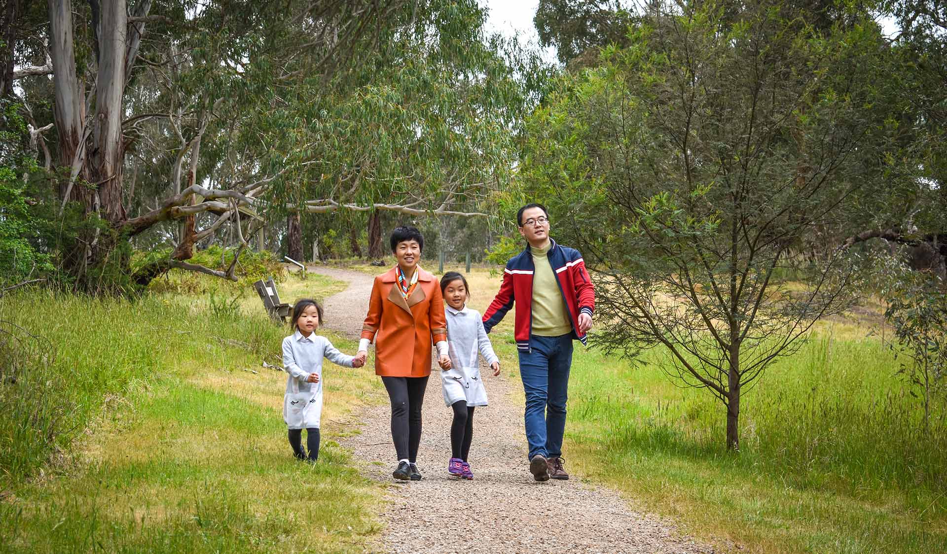 A family walk along a sealed path in Westerfolds Park.