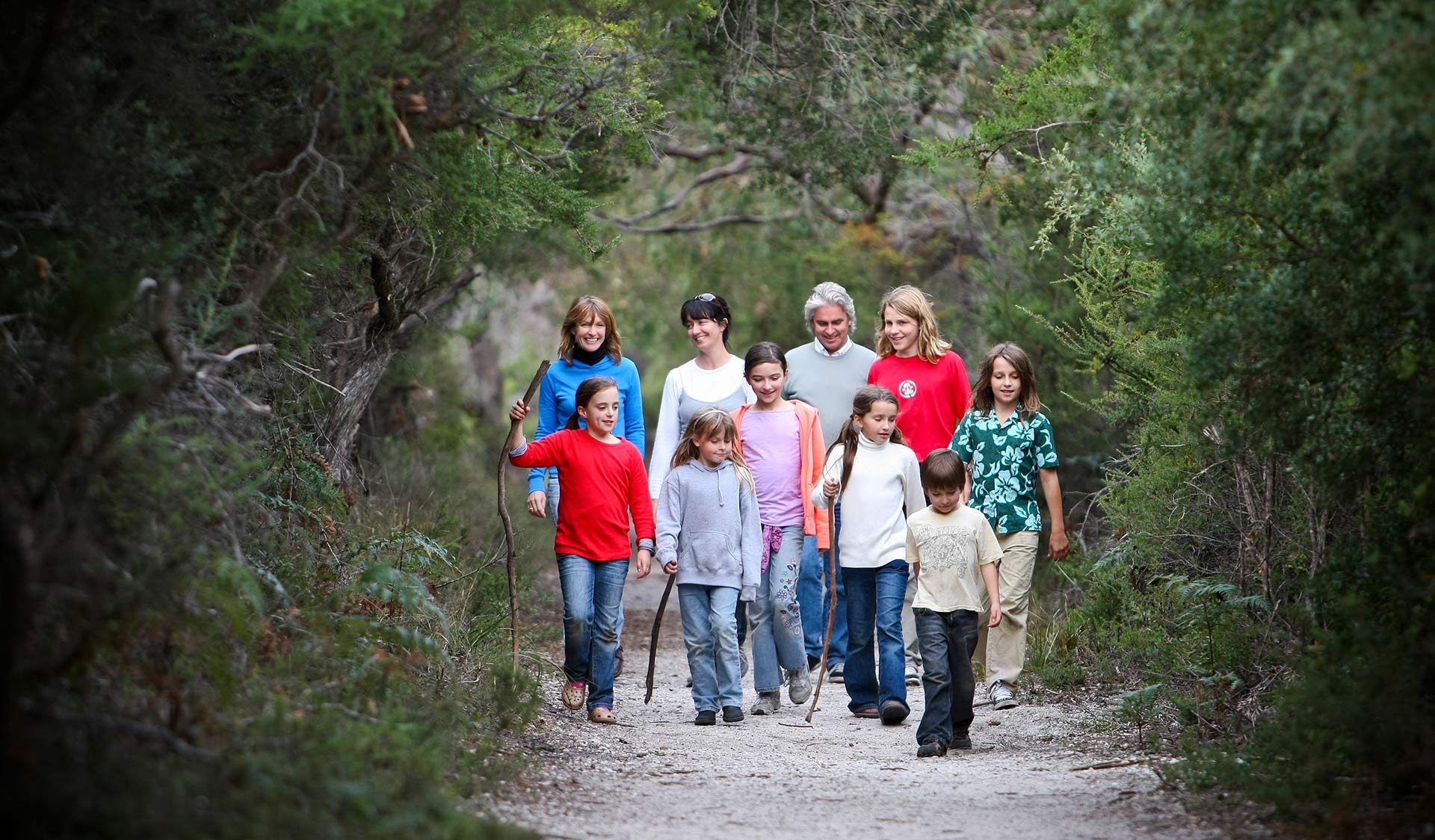 Two families walk along the Lilly Pilly Gully walk.