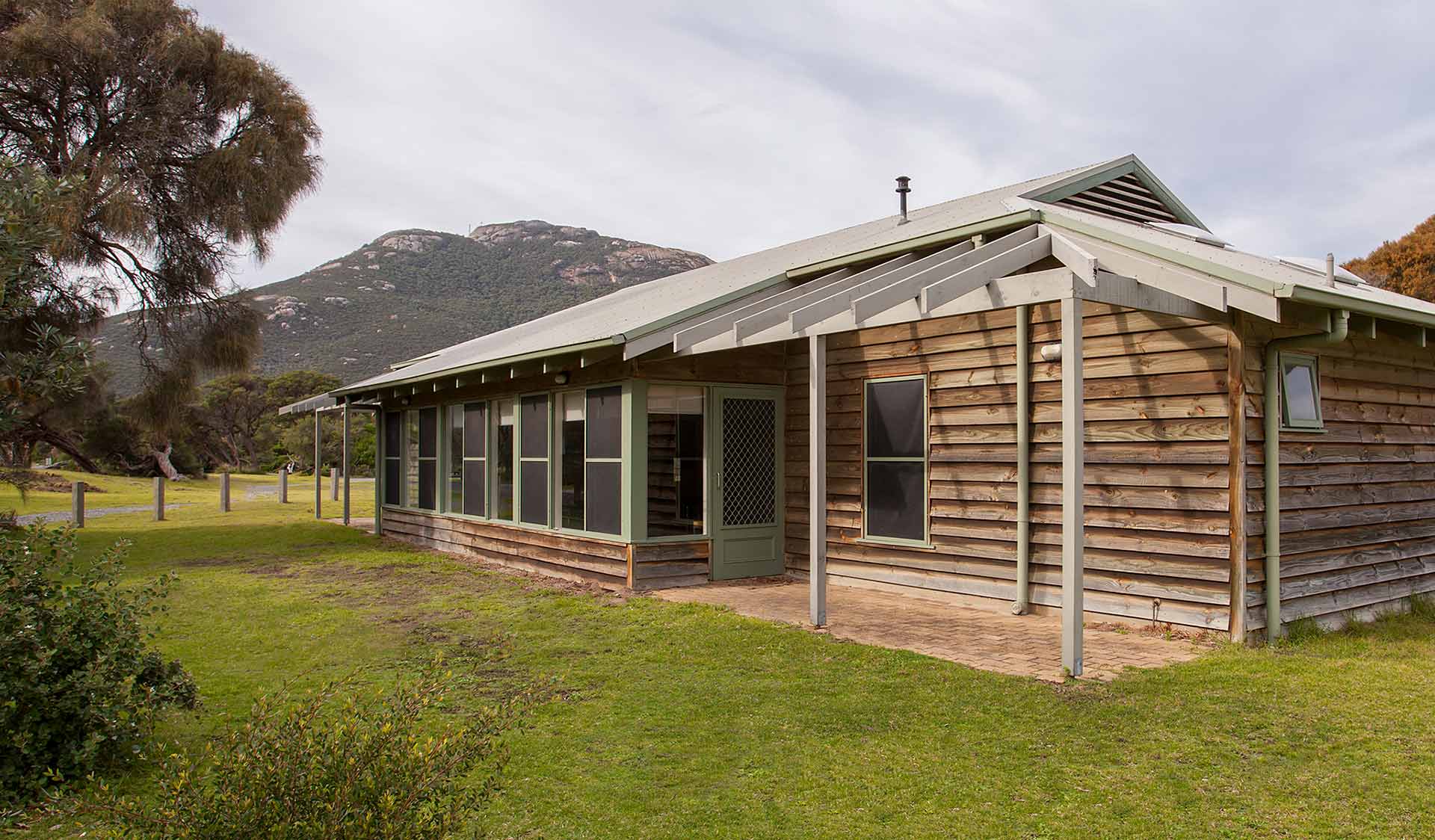 The exterior of a group lodge in Tidal River with Mount Oberon in the background at Wilsons Promontory National Park 