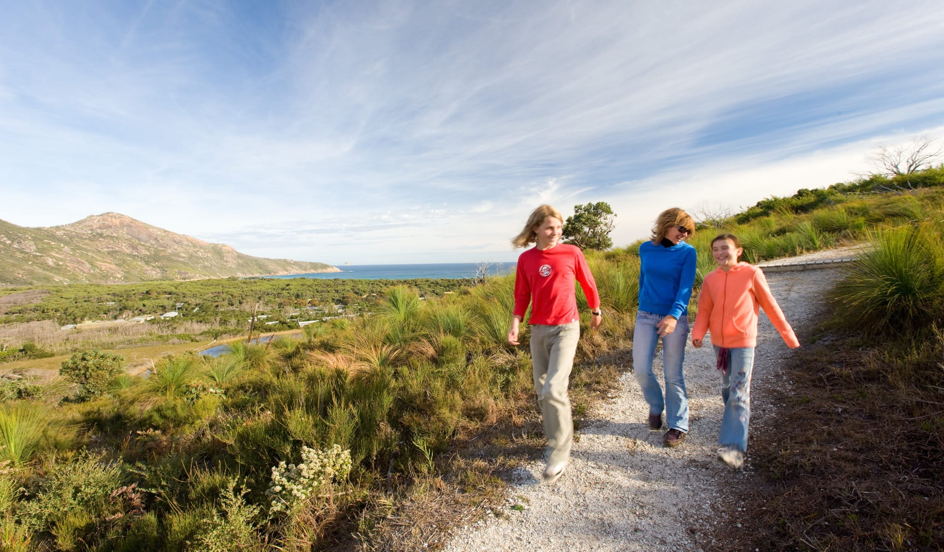 Family walks together on a coastal track at Wilsons Promontory