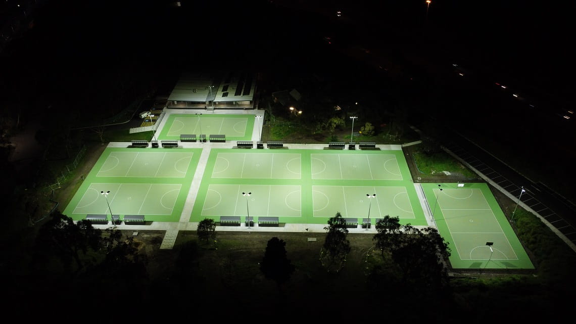 Birdseye view of the Yarra Bend Netball Courts lit up at night.