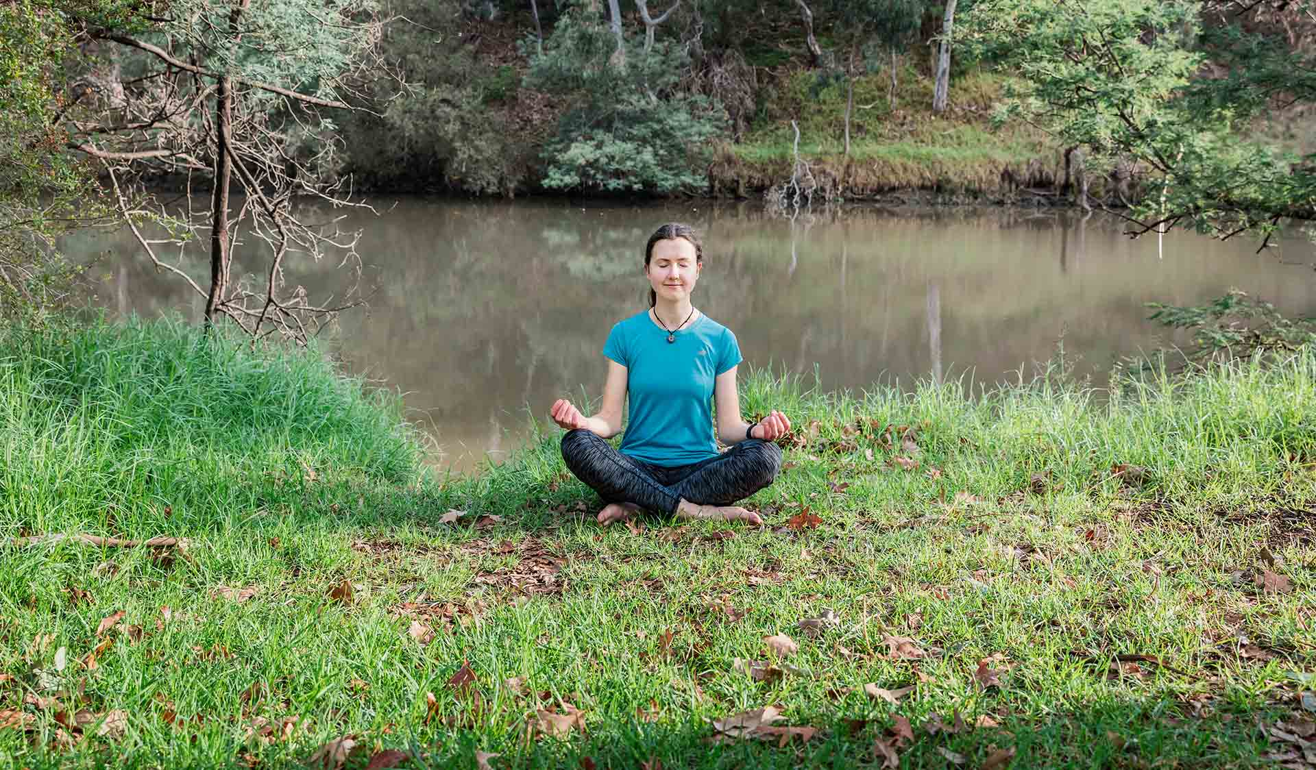 A women practices Yoga on the banks of the Yarra River at Yarra Bend Park.