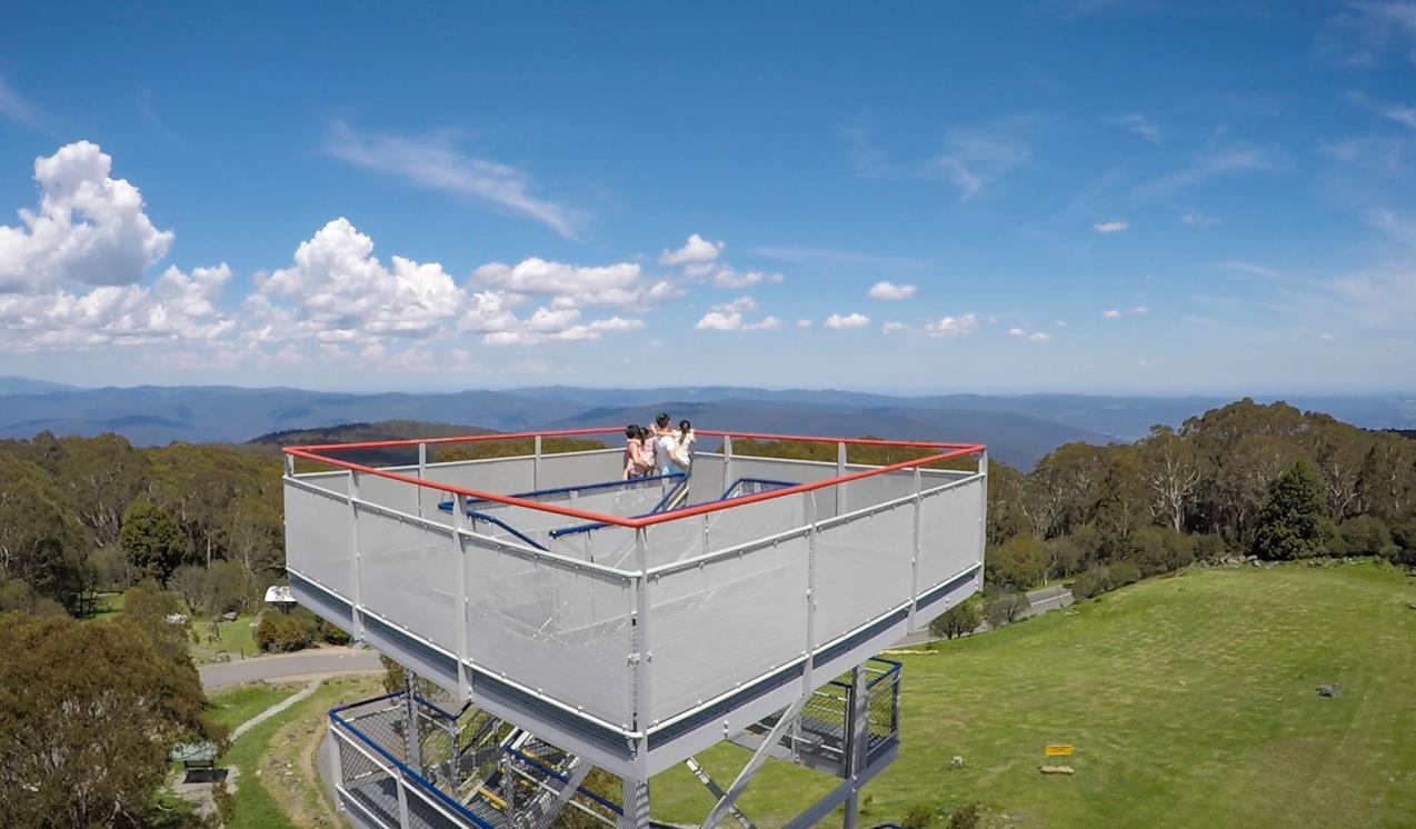 A family take in the view of the Yarra Ranges from the elevated platform at Mt Donna Buang.