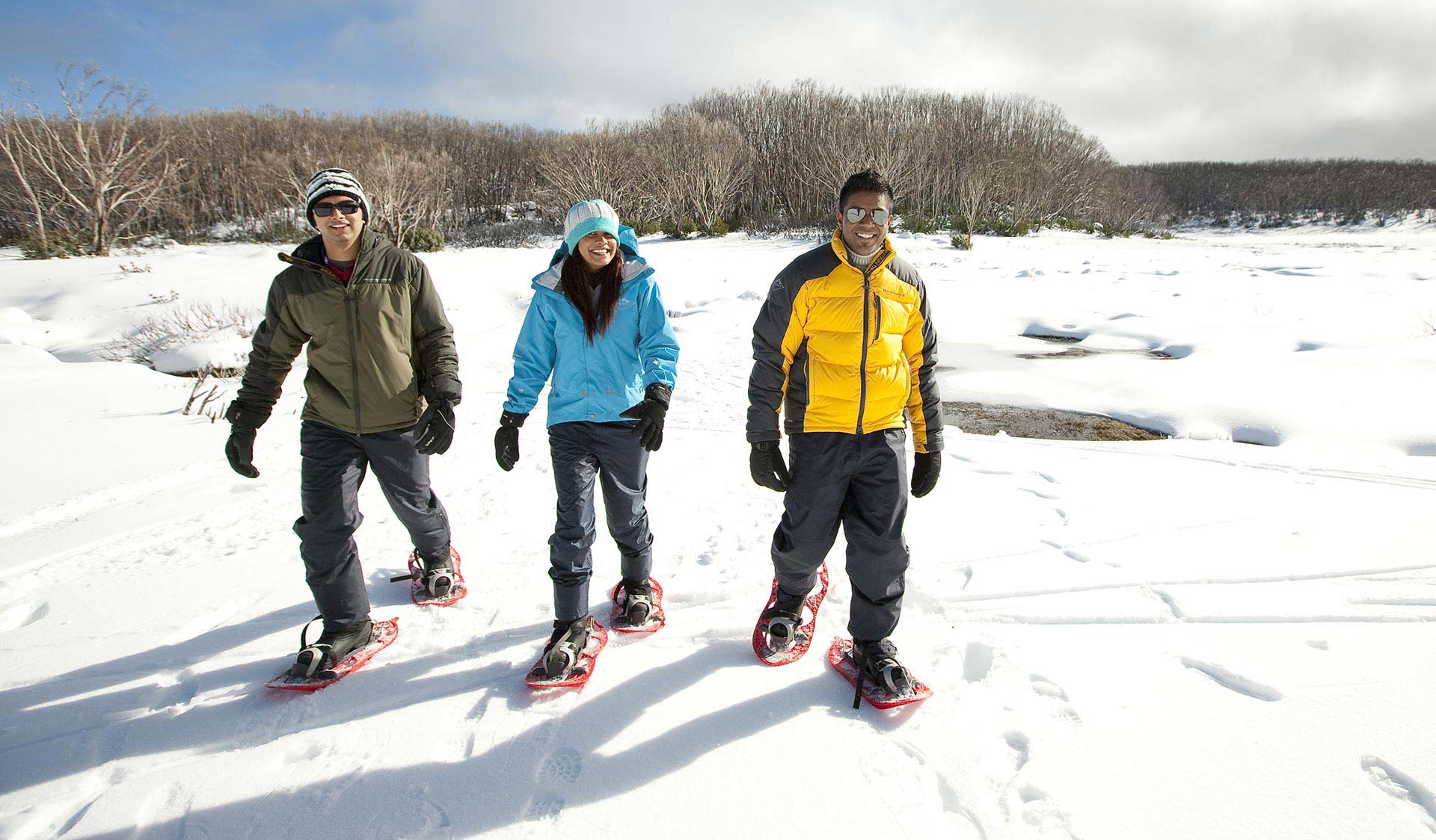 Three friends go snow shoeing at Lake Mountain during Winter.