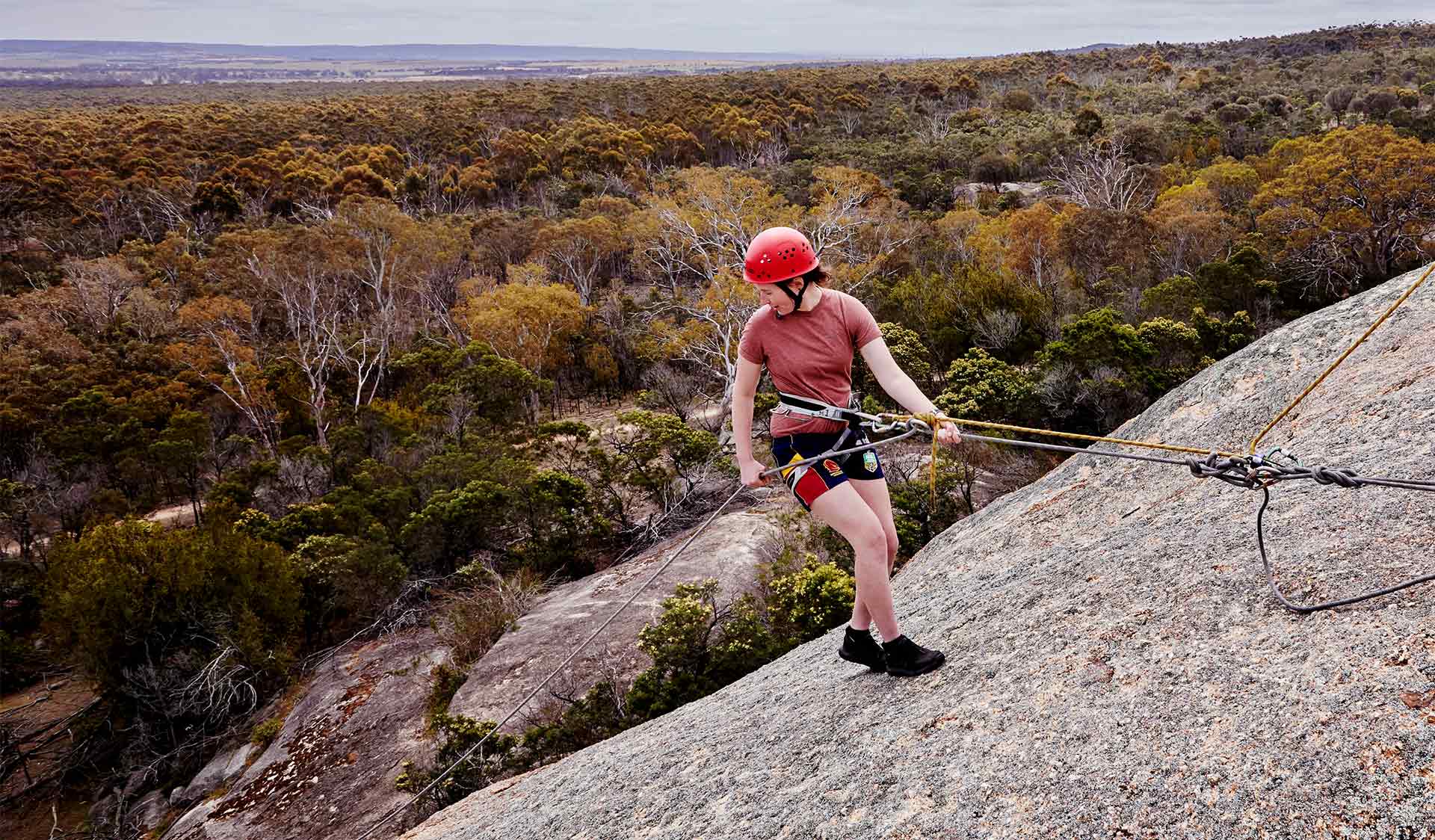 A young girl abseiling at Big Rock in You Yangs Regional Park