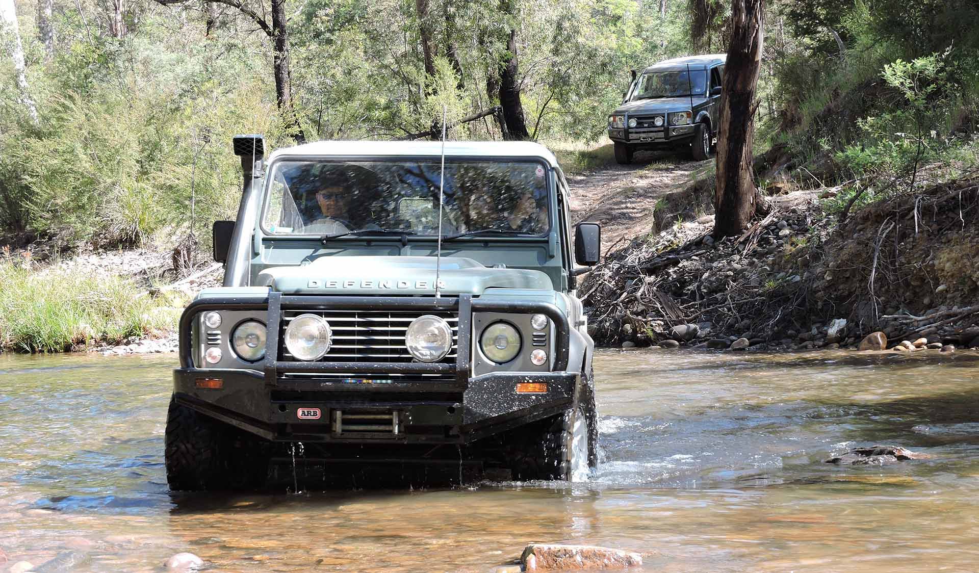 A Land Rover Defender attempts a river crossing in the Alpine National Park.
