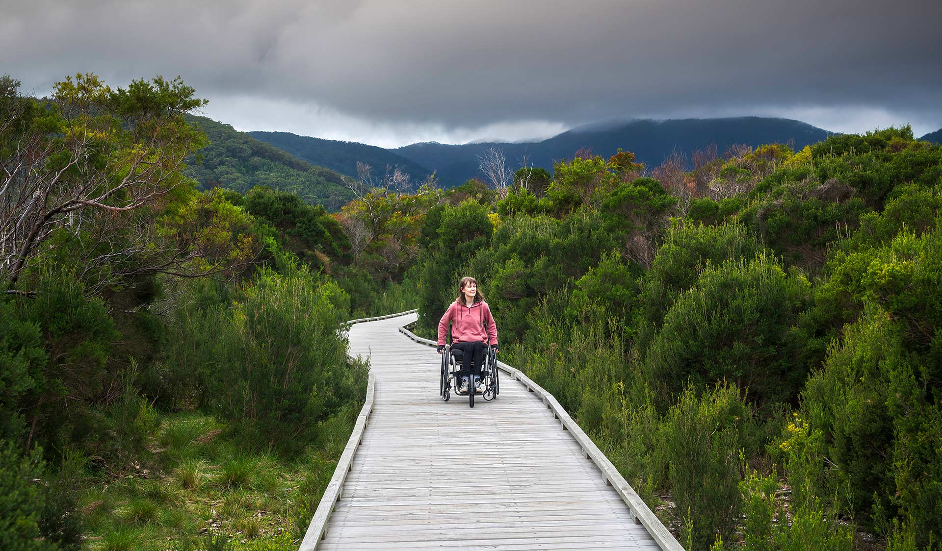 A women in a wheel chair explores Wilsons Promontory by board walk.