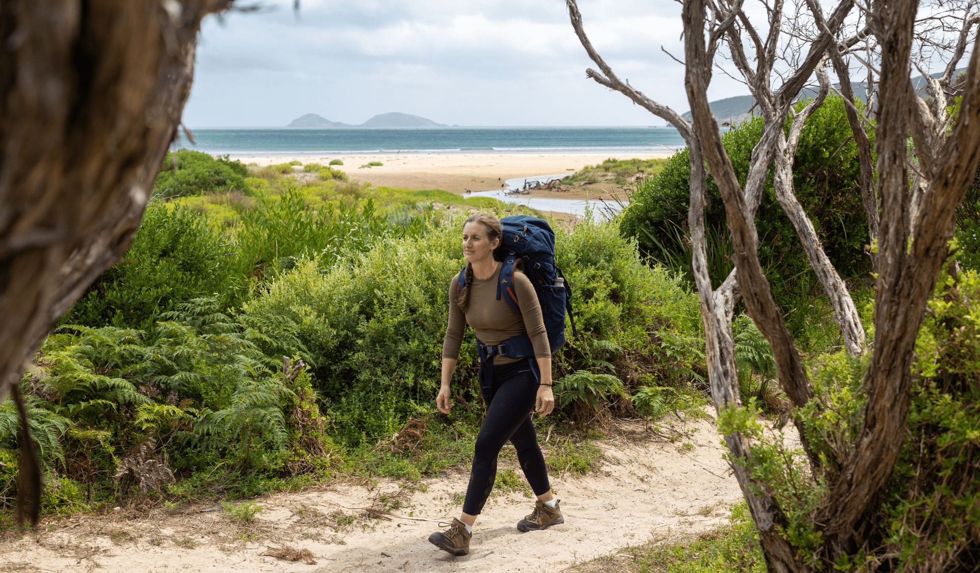 Hiker walking along trail, approaching Oberon Bay